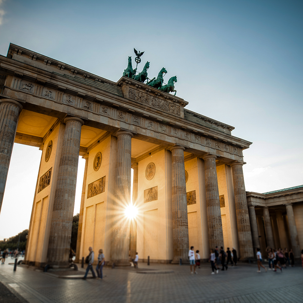 Die Sonne strahlt durch das Brandenburger Tor in Berlin.