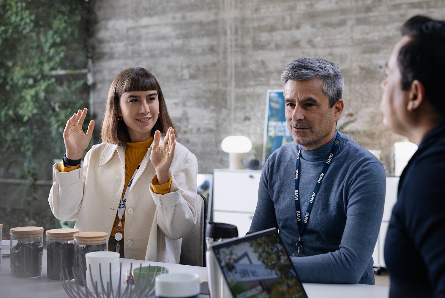 Drei Kolleg:innen unterhalten sich in einem modernen Büro.