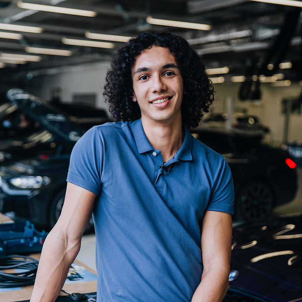 BMW intern Raphael in a modern automotive workshop