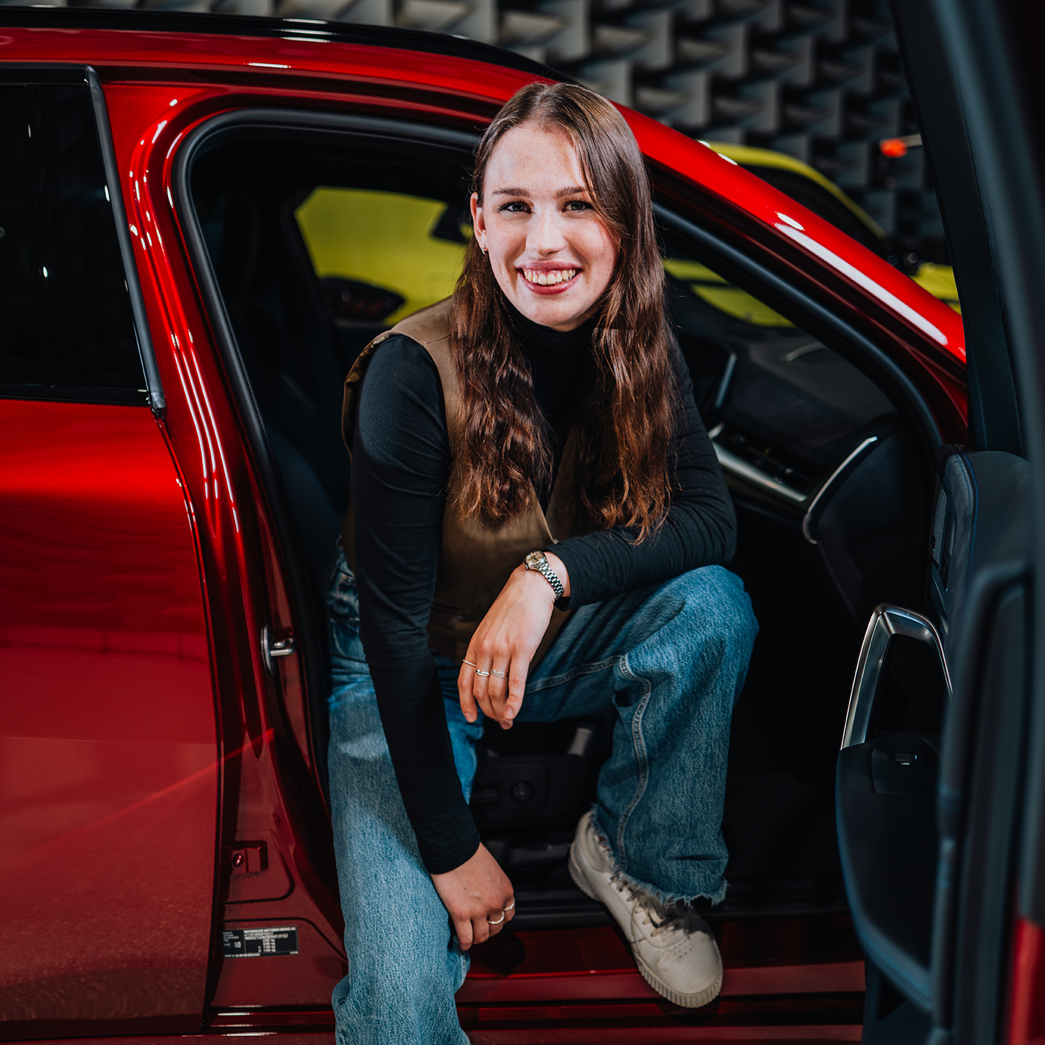 BMW apprentice Clara in a red BMW X2