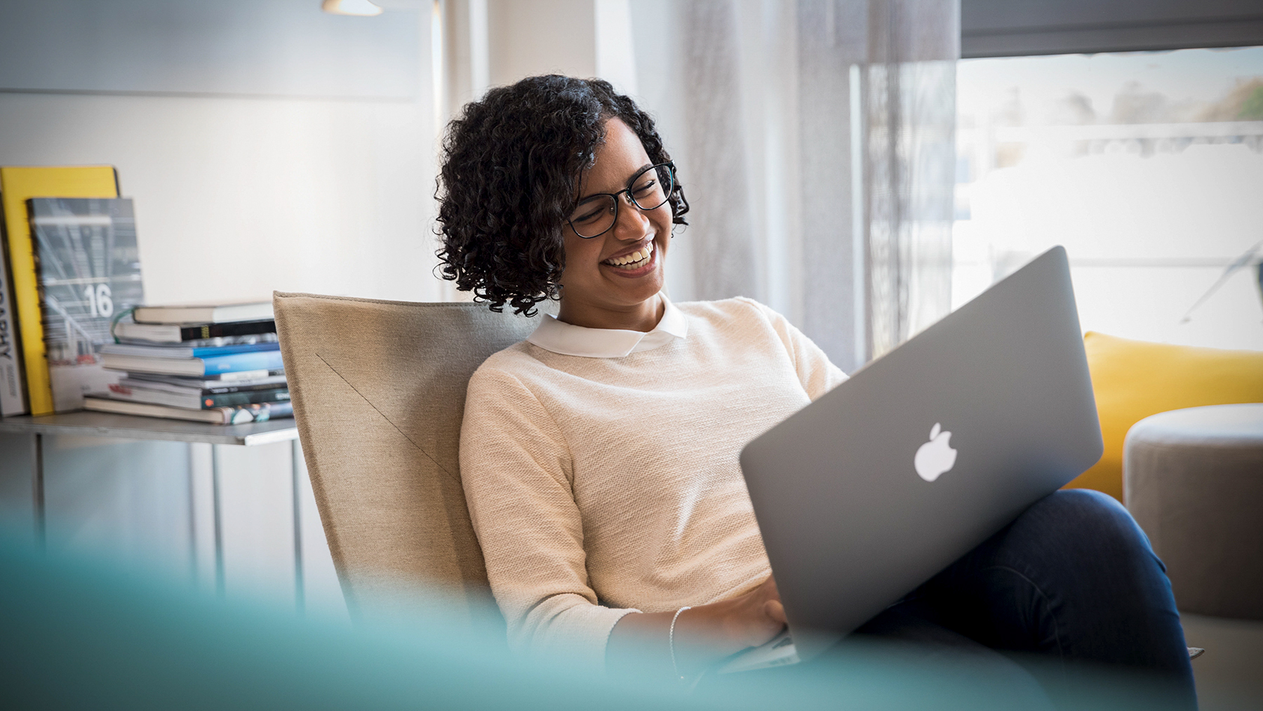 A BMW employee working on her computer, laughing.