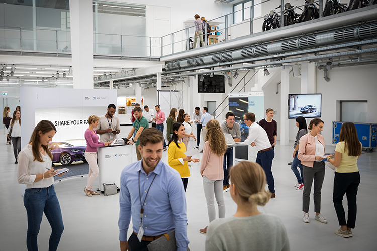 A group of people at an networking event at the BMW Group.