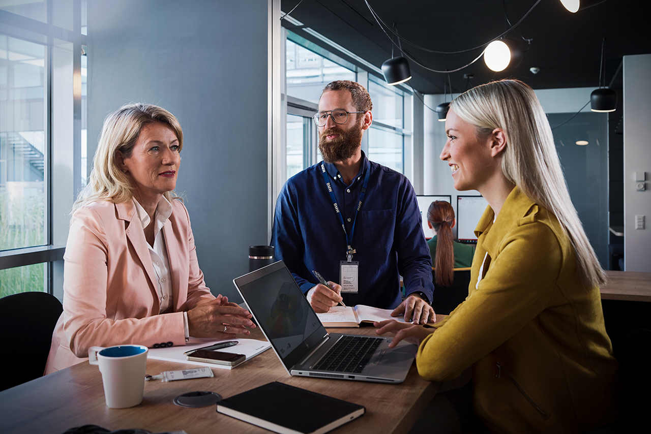 Three employees having a chat in the office