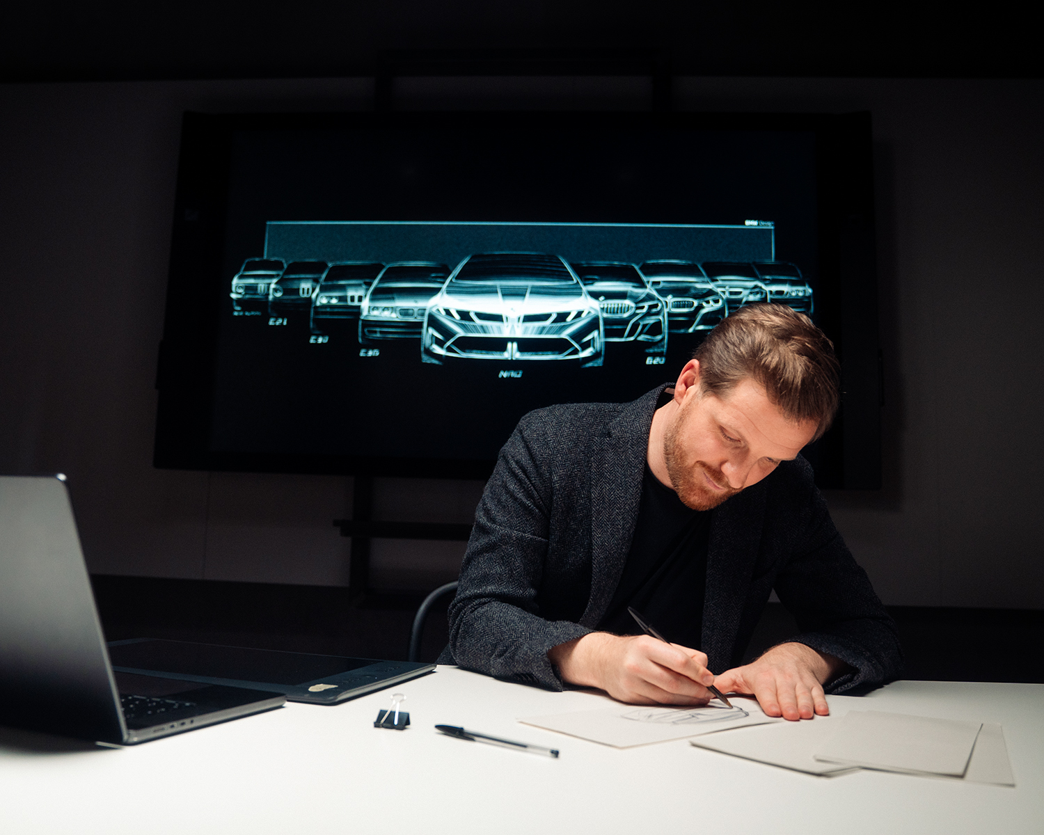 Designer Anders is sketching designs at his desk