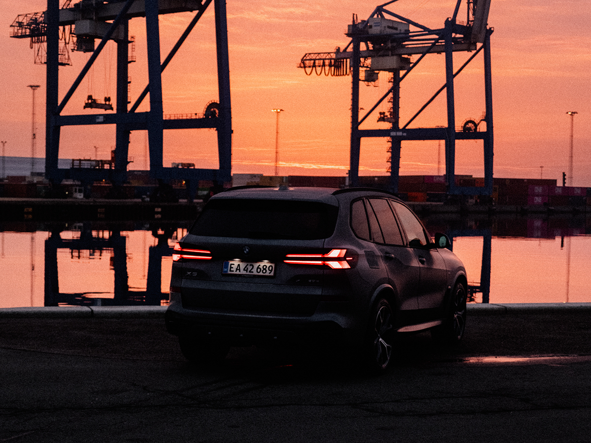 BMW X5 at a pier during sunset