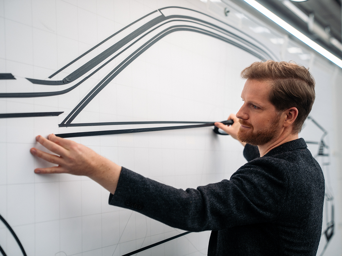 Designer Anders doing sketches on a wall, behind-the-scenes material