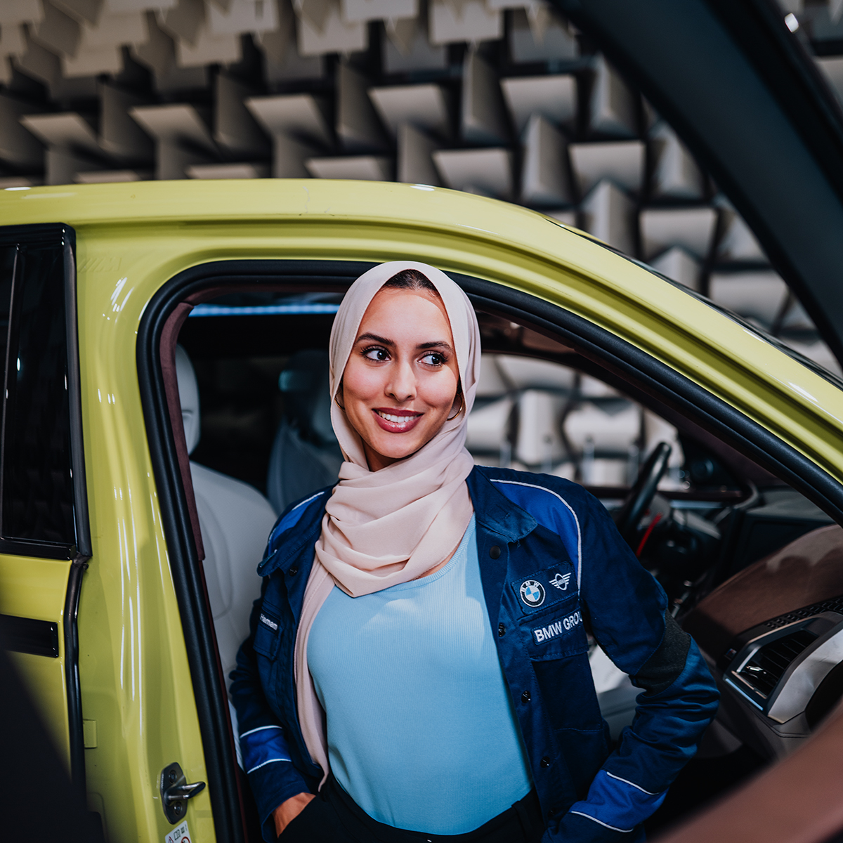 Yian stepping out of a yellow BMW XM.