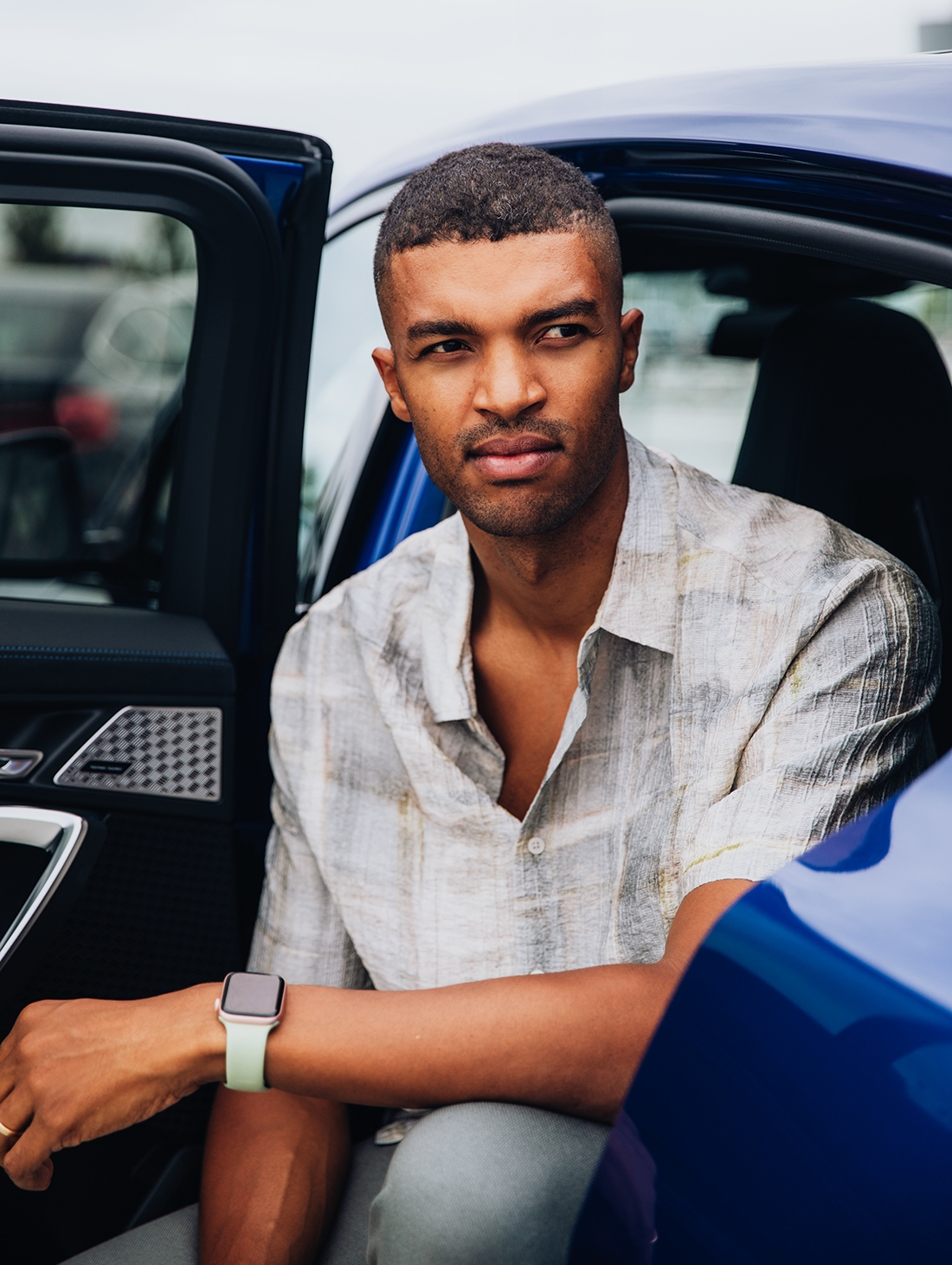 Engineer at the BMW Group sitting on the backseat, looking at something.