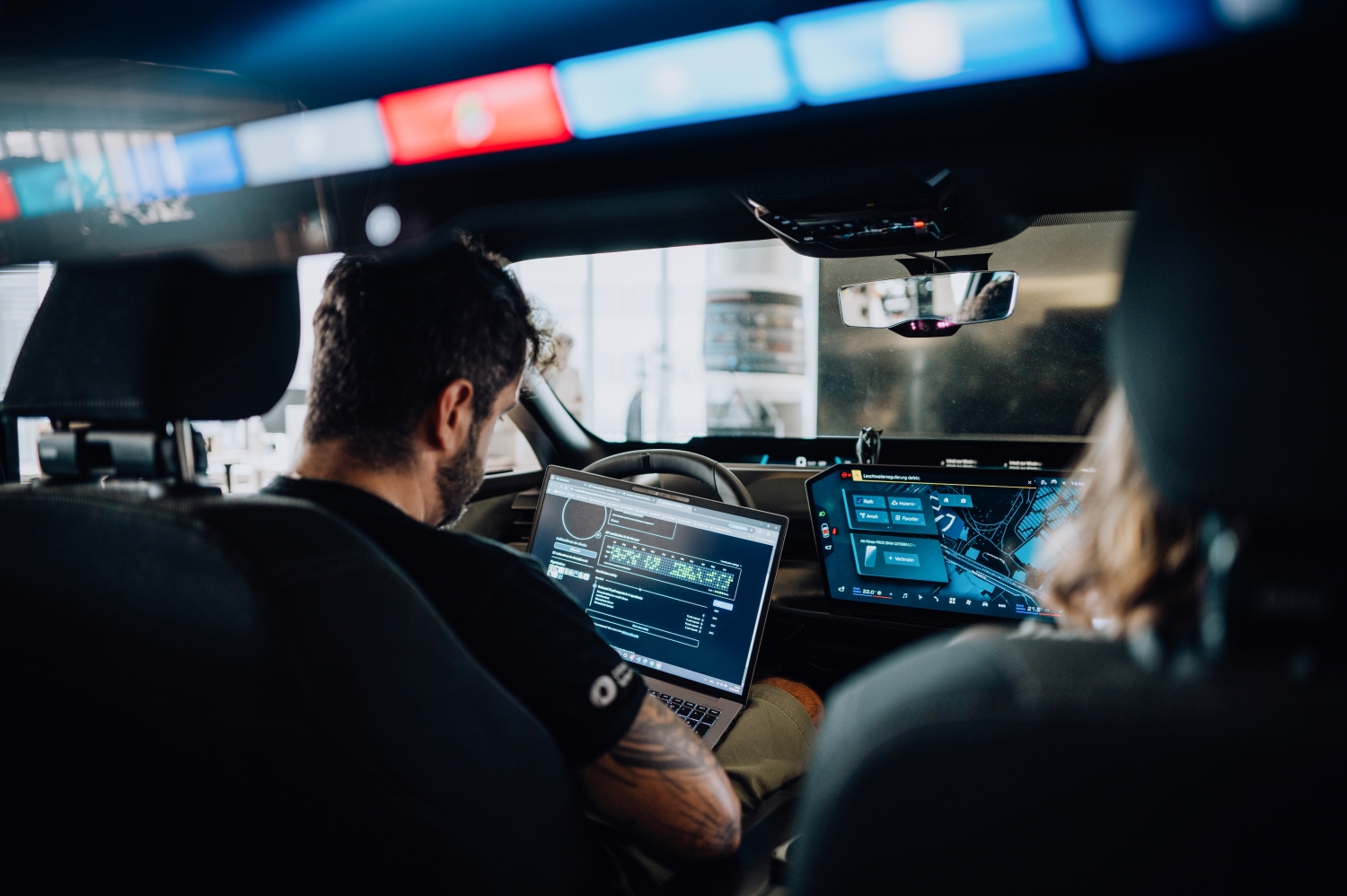 BMW software architect Matheus in a vehicle mockup at the research center