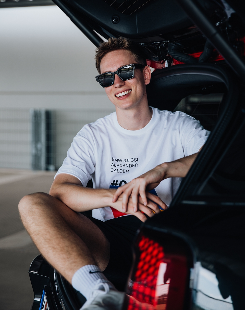 Student sitting in the trunk of the car.