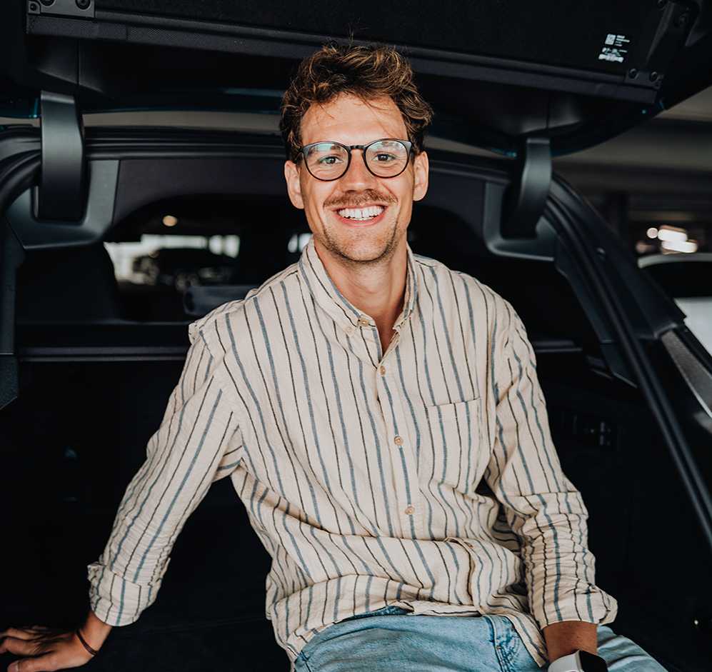 PhD student Phillip laughs in the trunk of the BMW iX.