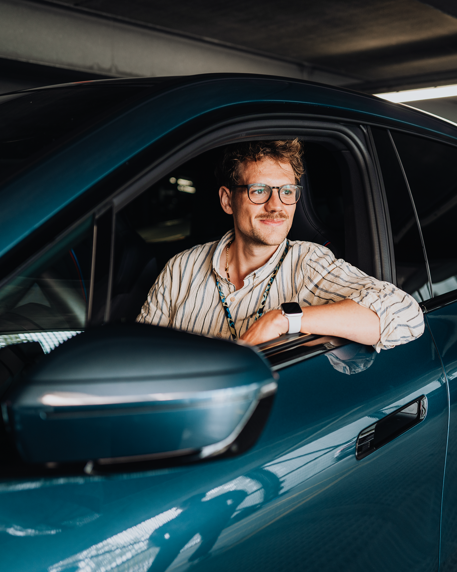 PhD student Phillip looks out the window from the driver’s seat of a BMW iX.