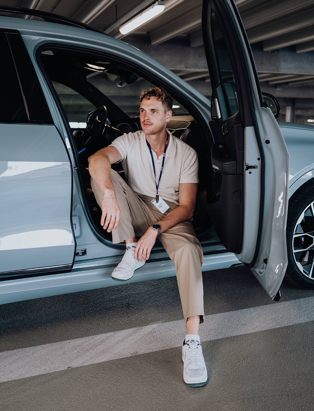 Engineer sitting in the door frame of a BMW X7.