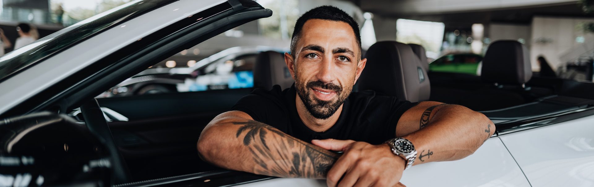 BMW employee leaning out of a BMW M4 Convertible.