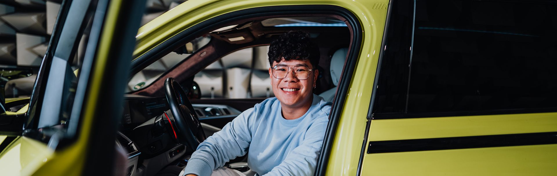 Yian in the drivers seat of a BMW XM.