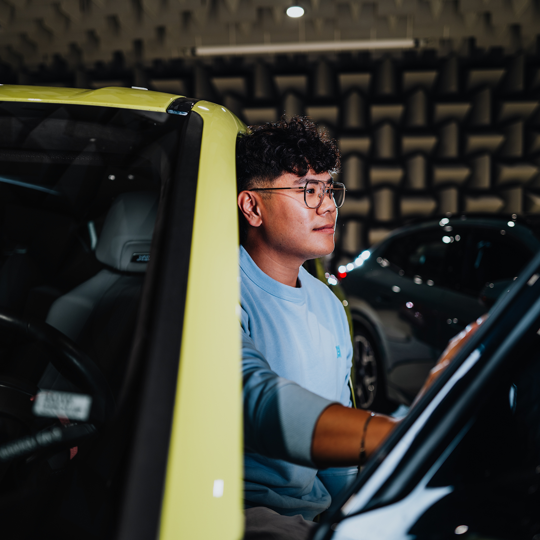 Yian stepping out of a yellow BMW XM.