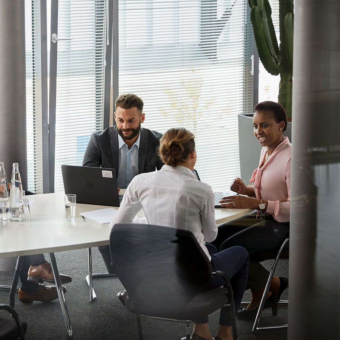 BMW legal services team collaborating in a modern office environment.