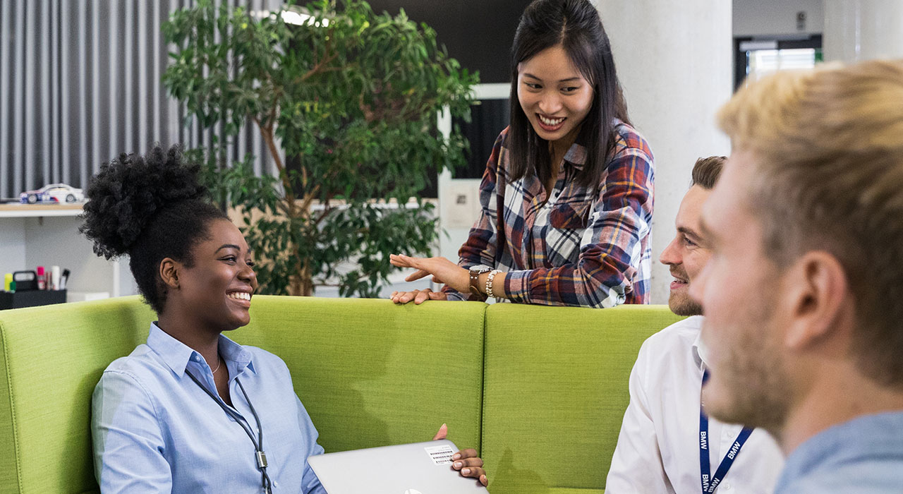 Collaborating employees in human ressources at the BMW Group sitting together.
