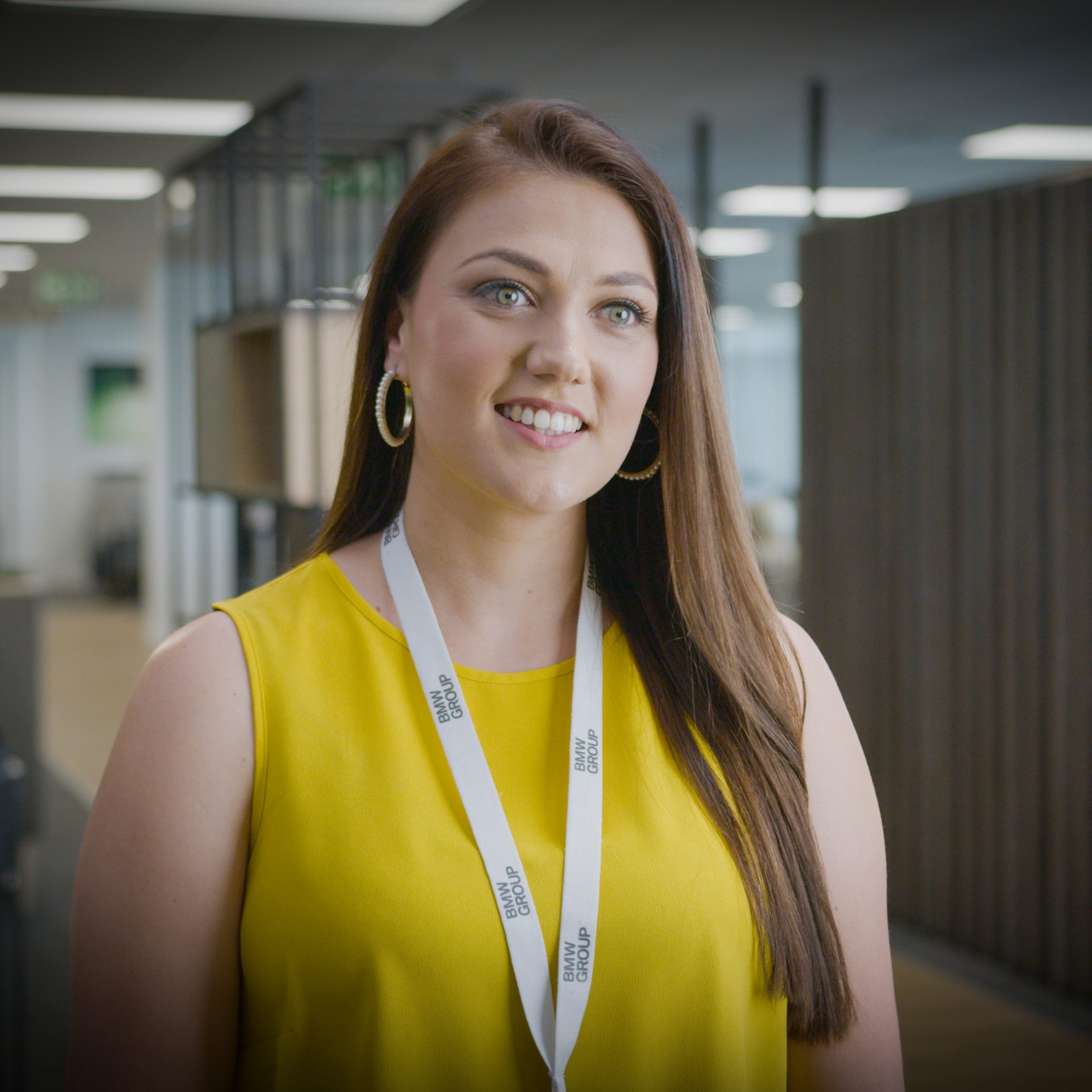 A female business manager smiling at the camera.