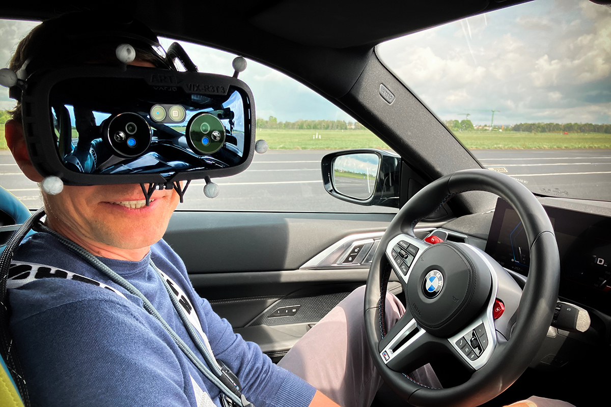 BMW In-house Counsel Alex with mixed reality glasses in the BMW M4.