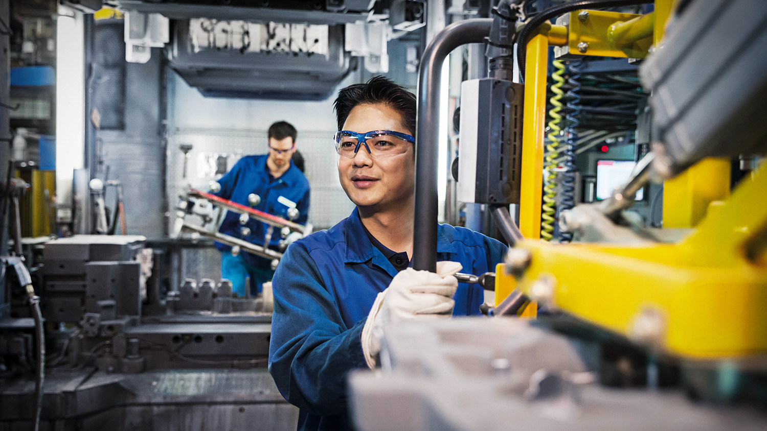 Employee in Foundry working on machines.