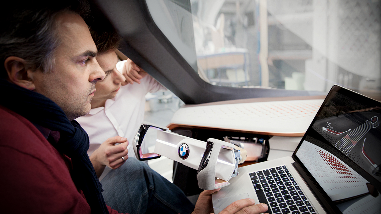 Two colleagues analysing data on a monitor in a test vehicle.