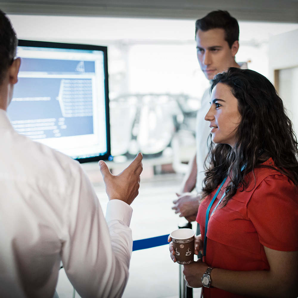 Consultation between salesperson and customer at a BMW dealership.