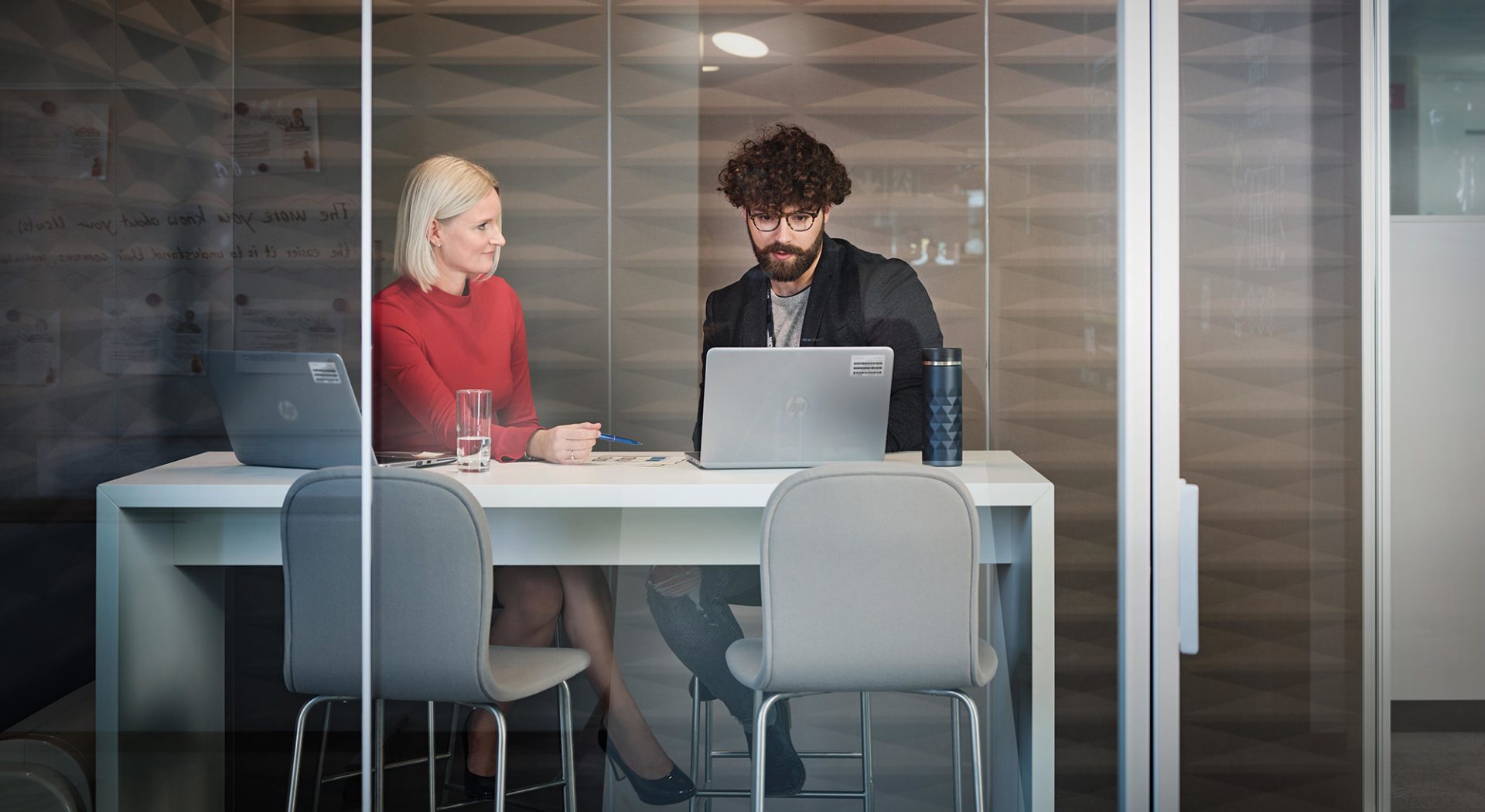 Two BMW collegaues at work in a meeting room.