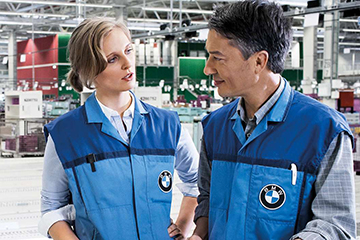 Two BMW employees in conversation at the Hodenhagen distribution center.