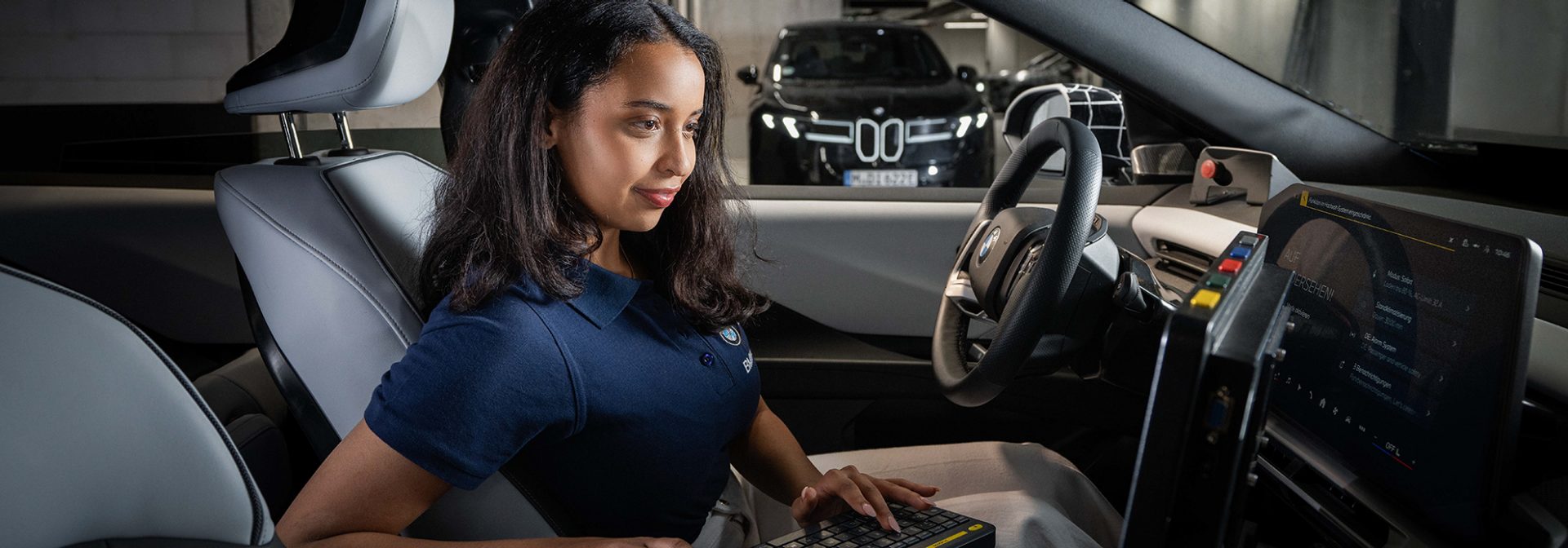 Trainee with laptop in a vehicle