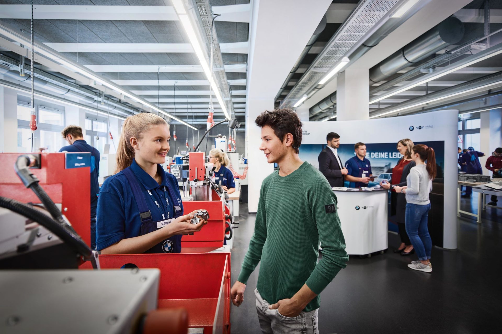 Young professionals engaging at a BMW career event.