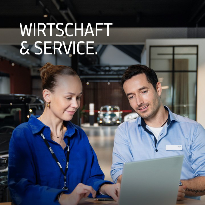 Apprentice with her supervisor in a dealership