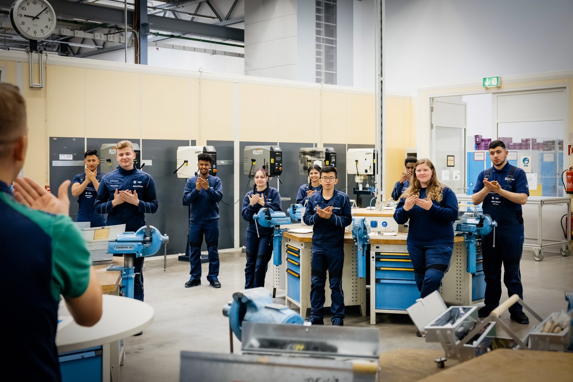Deaf apprentices in a workshop, actively participating and learning together.