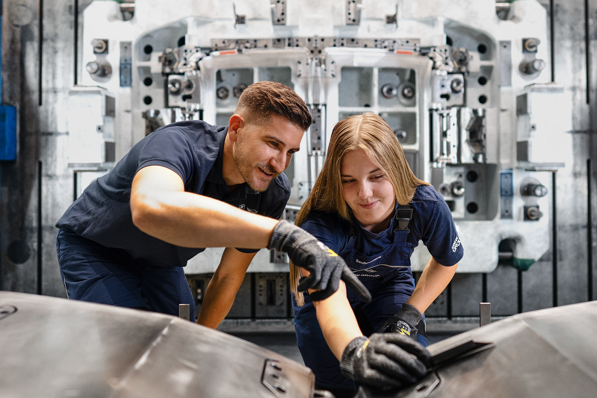 BMW Group apprentices working as tool mechanics in a workshop.