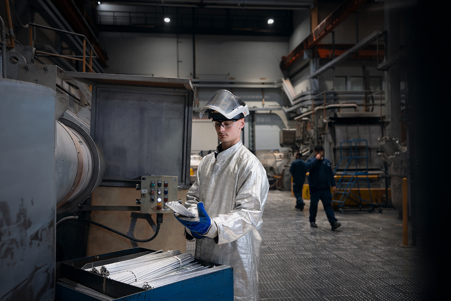A young foundry apprentice engaged in machine operation in a manufacturing setting at the BMW Group.