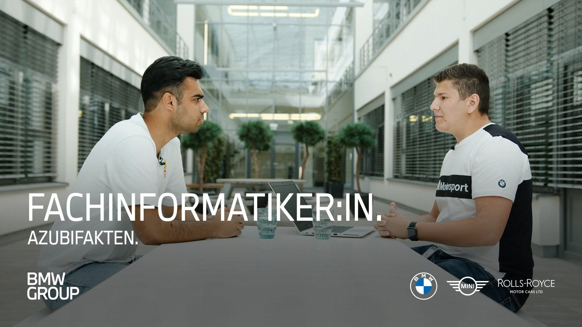 Young professionals engaged in a conversation about IT careers at BMW Group.