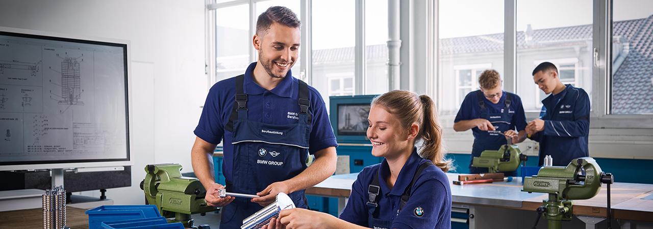 Two students working very precisely in a laboratory during their internship at the BMW Group.