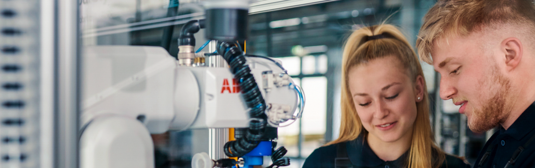 Two Mechatronics apprentices working with a machine