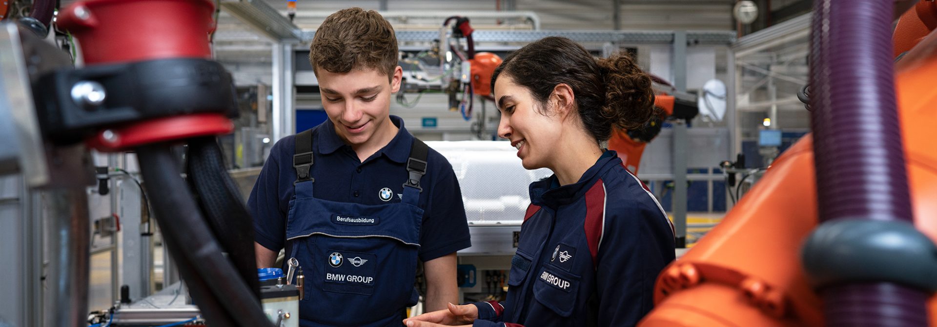 Two Mechatronics apprentices working with a machine.