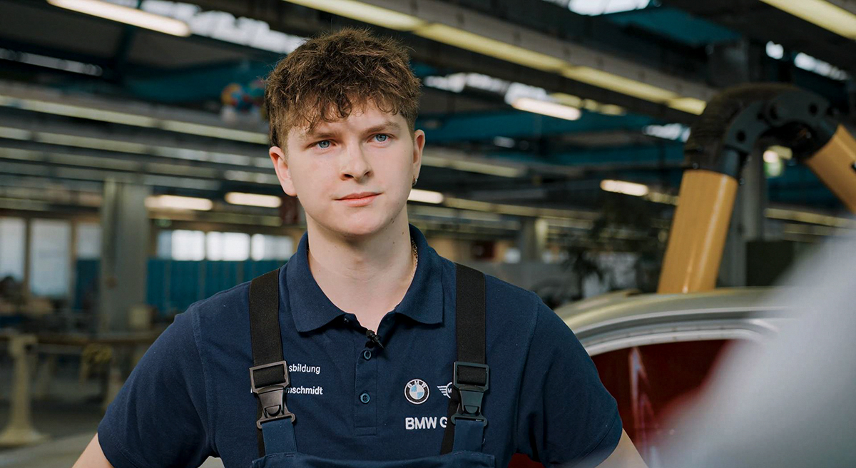 Young apprentice bodywork and vehicle construction mechanic in a BMW Group workshop.