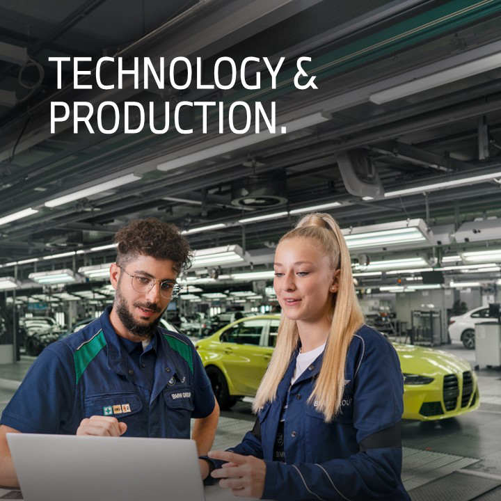 Two dual students having a conversation in the production hall with a BMW M3 in the background