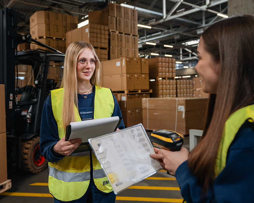 Three dual students having a conversation at a desk