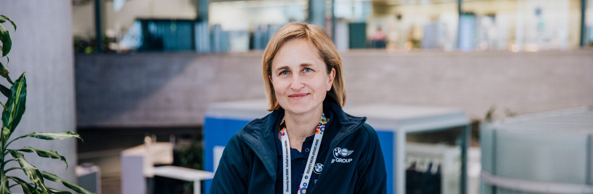 A female Recruiter for apprenticeships at the BMW Group smiling at the camera.