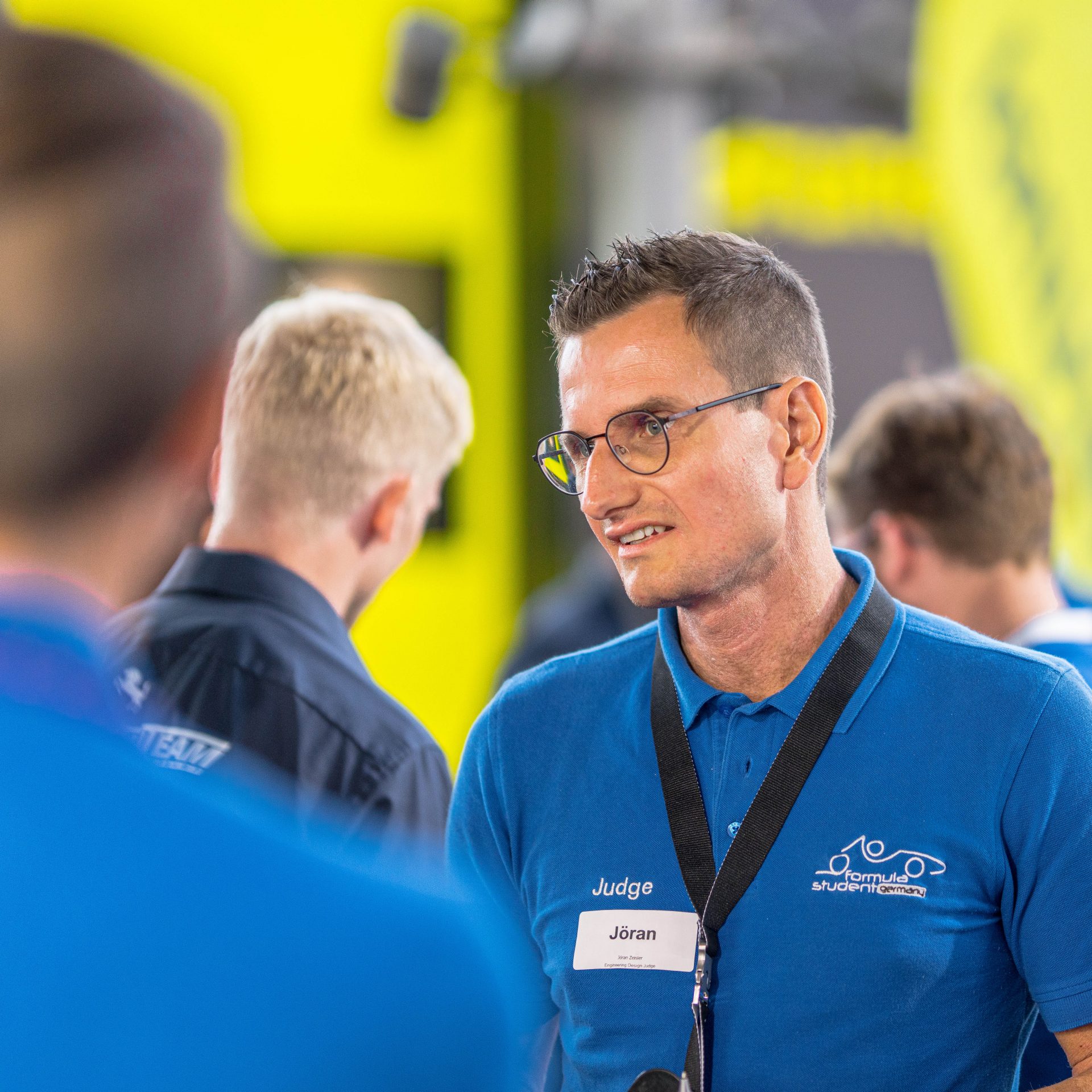 A BMW Employee talking to his colleagues.