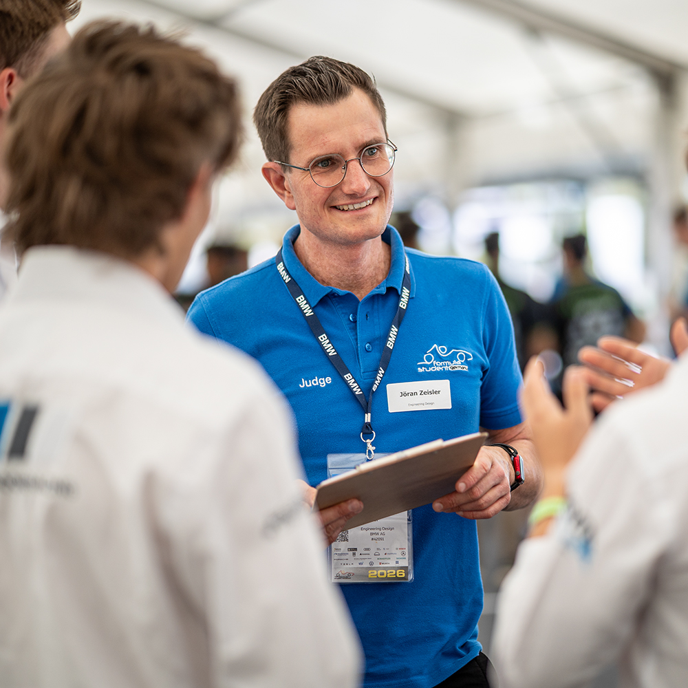 A BMW Employee talking to students at Formula Student Hockenheim