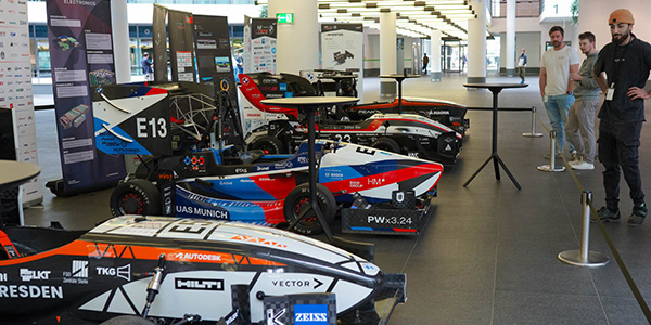 Gruppenfoto des BMW Formula Student Teams mit Rennwagen.