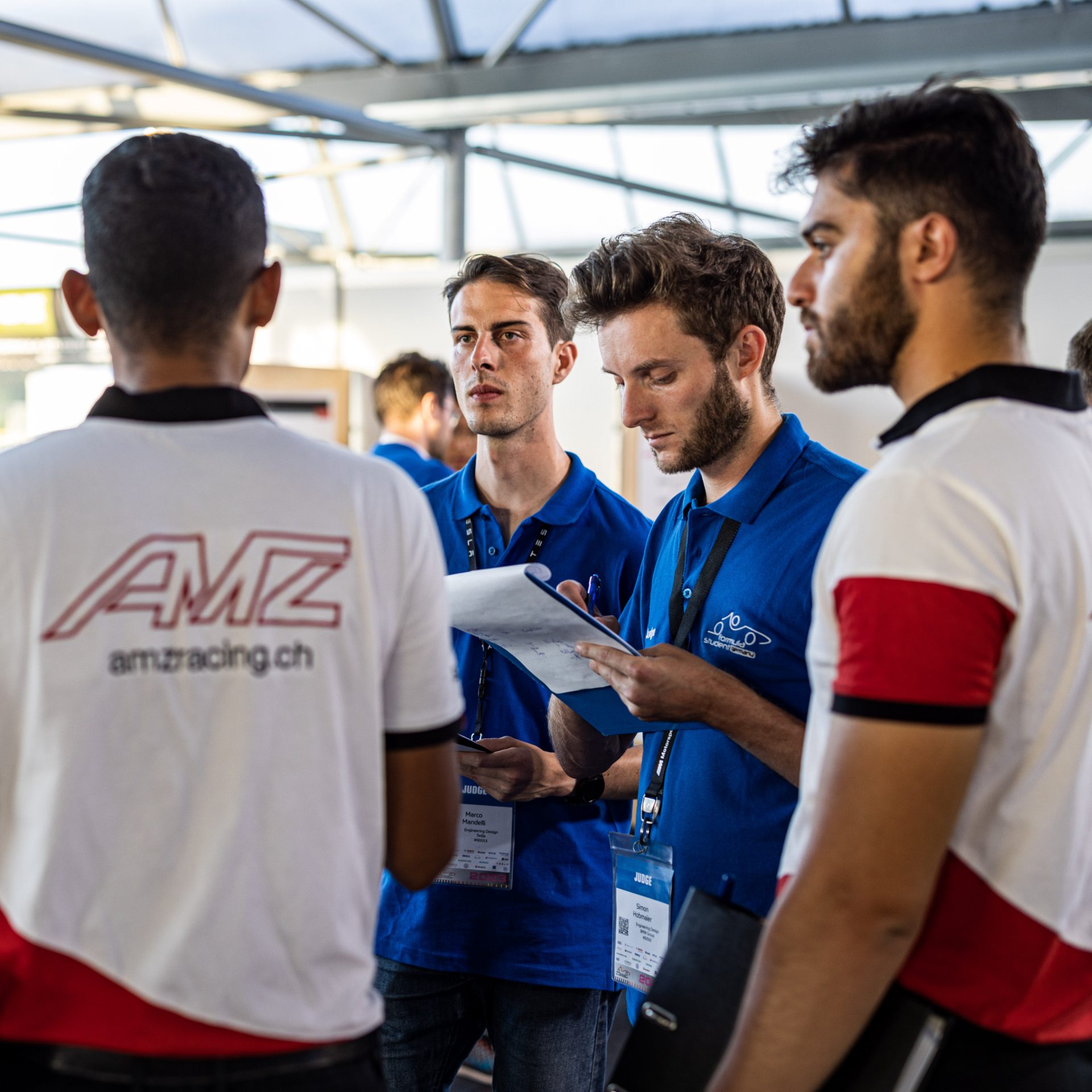 AMZ Judging Team standing together having a conversation