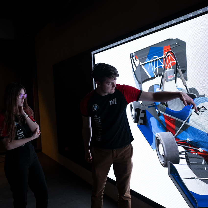 Two Students are talking about the Design of the Formula Student race car.