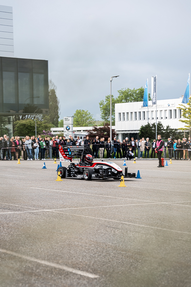 A student in the race car on the test track.