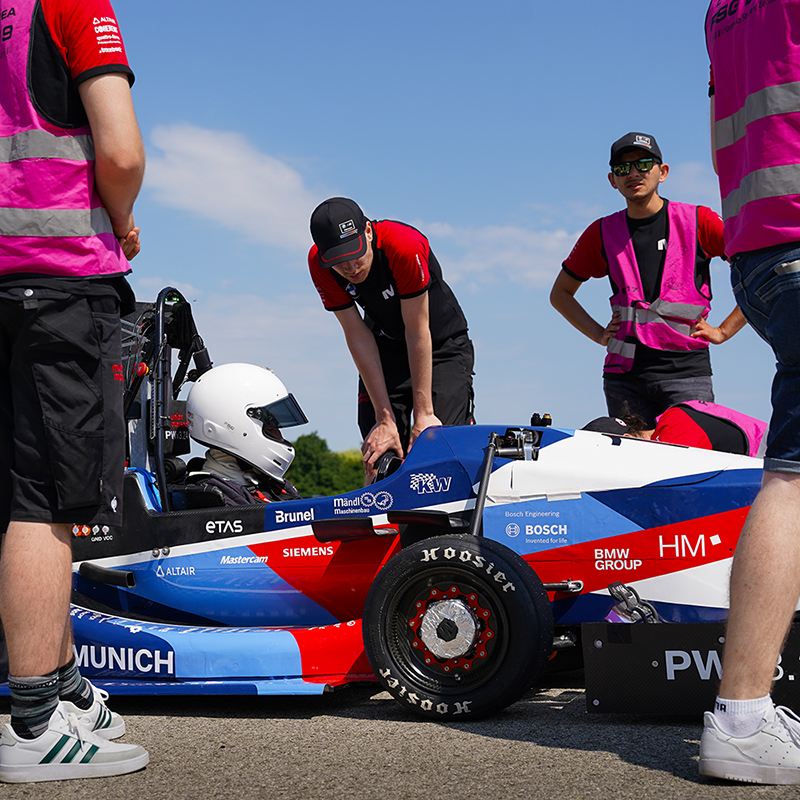Formula Student team checking last things before the car starts the race.